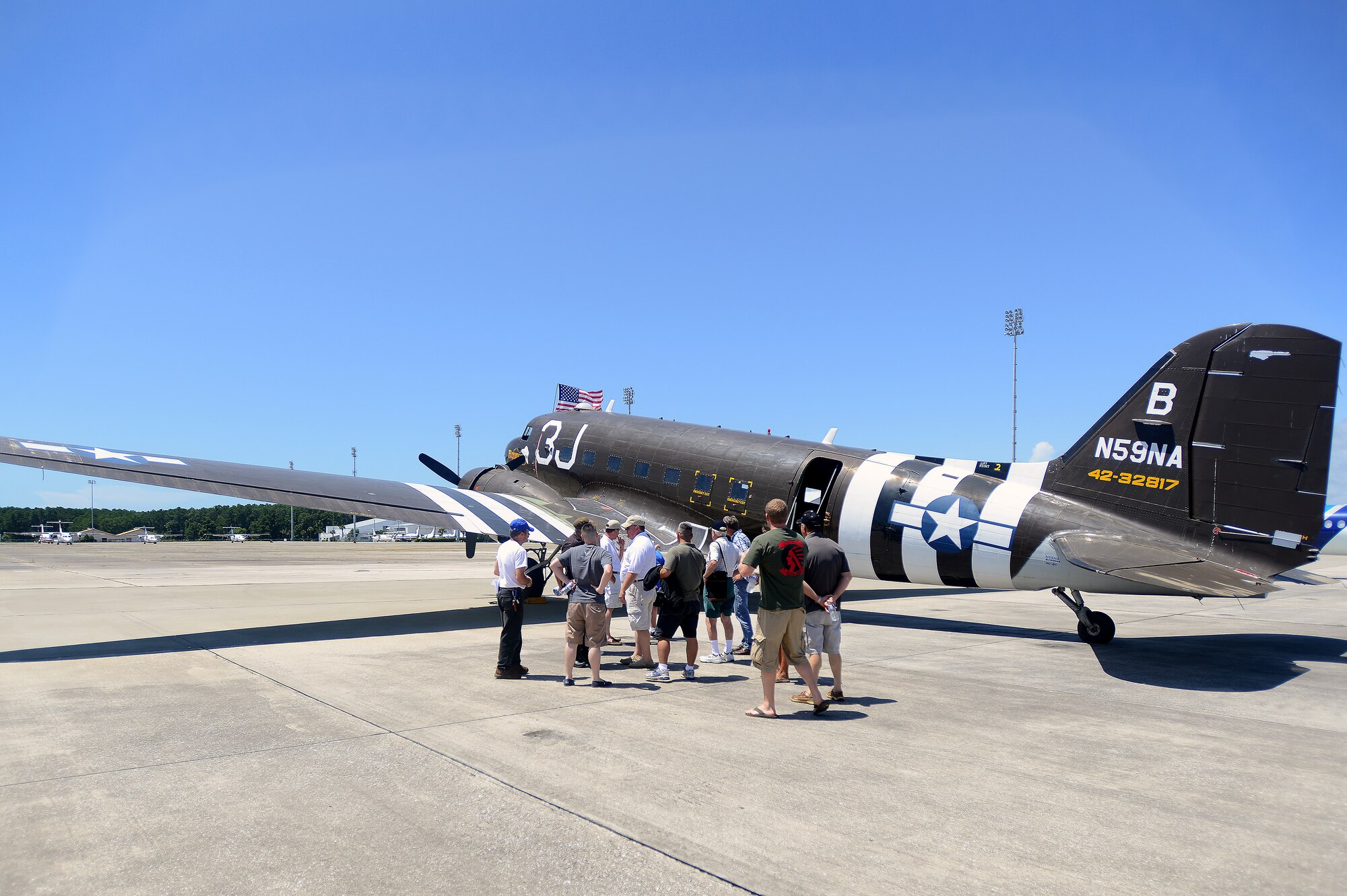 Passengers and crew discuss the features of the retired Army C-47 that are featured in the Salute from the Shore, Myrtle Beach Airport, S.C., July 4, 2013 This C-47 was flown in WW2 and then featured in multiple Hollywood films such as: “The Dirty Dozen,” “War and Remembrance,” and “The Eagle has Landed” (U.S. Air Force photo by Airman 1st Class Jensen Stidham/Released)