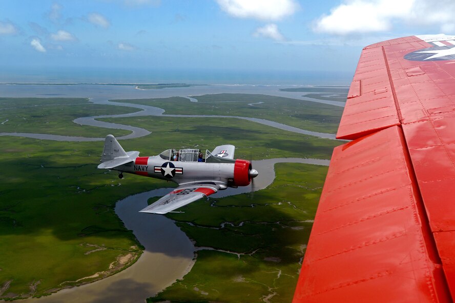 A T-6 Texan flies beside a retired Navy C-45 during the Fourth of July’s Salute from the Shore air parade on the coast of South Carolina, July 4, 2013 Vintage aircraft flew the coast in honor of Independence Day. (U.S. Air Force photo by Airman 1st Class Jonathan Bass/Released)