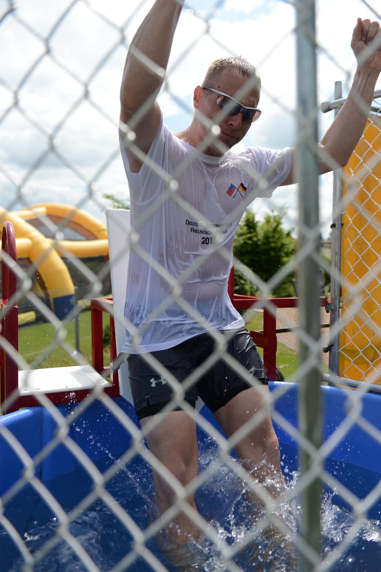 SPANGDAHLEM AIR BASE, Germany – U.S. Air Force Chief Master Sgt. Matthew Grengs, 52nd Fighter Wing command chief, mans the dunk tank during Super Saber Appreciation Day at the base pavilion near the Eifel Lanes Bowling Center July 4, 2013. The event included a number of activities including pony rides, a carousel and swings, and two bouncy castles. (U.S. Air Force photo by Airman 1st Class Gustavo Castillo/Released)