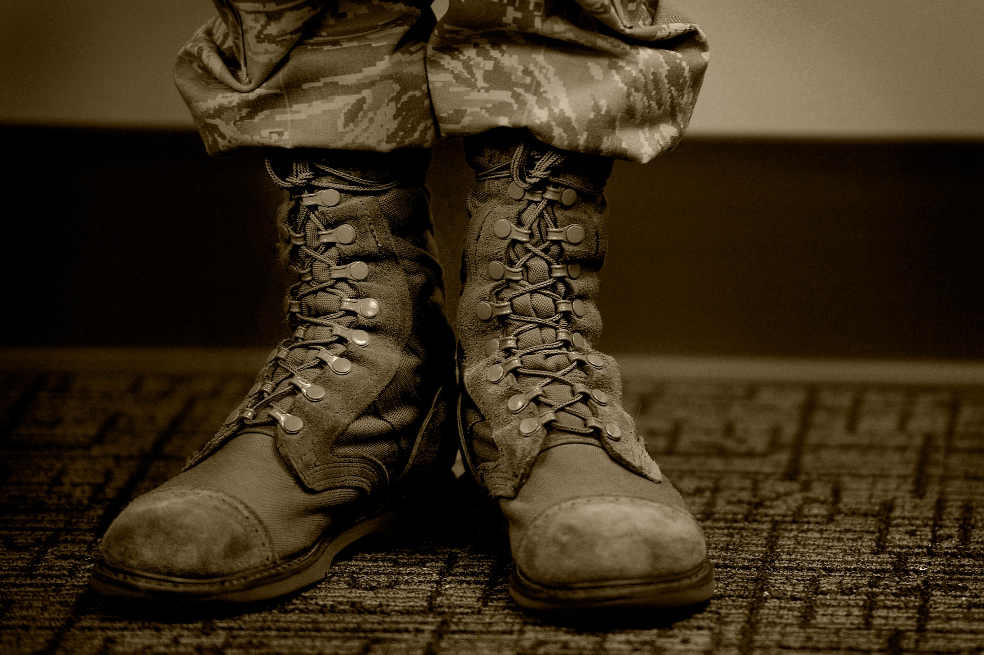 U.S. Air Force Staff Sgt. Alisha Martell, Air Forces Central intelligence analyst stands in her boots at attention for the last time as a U.S. Air Force NCO during her retirement ceremony, March 29, 2013, Shaw Air Force Base, S.C. Martell retired from active duty due to thyroid cancer which she battled throughout her Air Force career. (U.S. Air Force photo by Staff Sgt. Kenny Holston/Released)