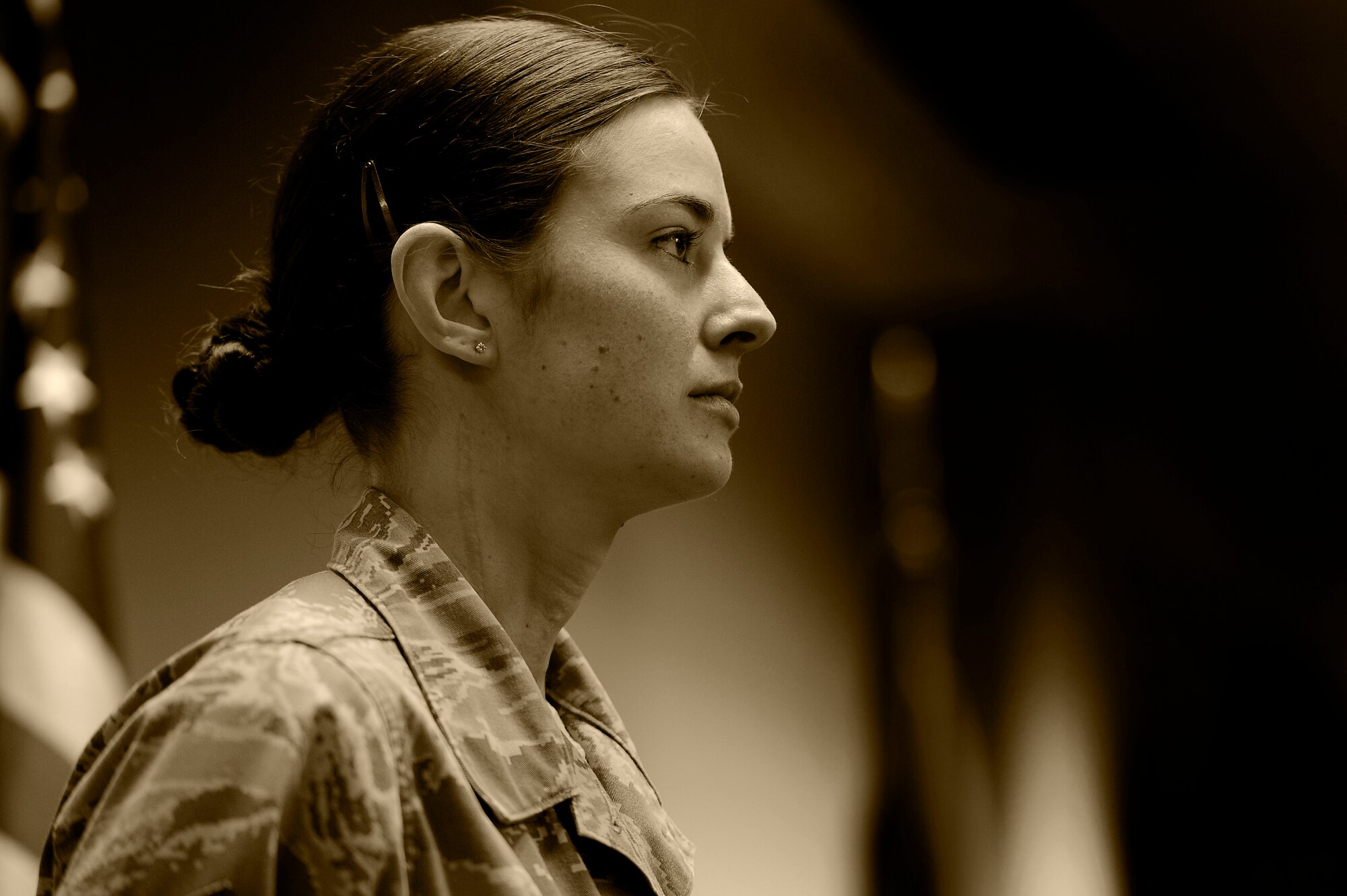 U.S. Air Force Staff Sgt. Alisha Martell, Air Forces Central intelligence analyst, stands at attention during the playing of the national anthem at her retirement ceremony, March 29, 2013, Shaw Air Force Base, S.C. Martell retired from active duty due to thyroid cancer which she battled throughout her Air Force career. (U.S. Air Force photo by Staff Sgt. Kenny Holston/Released)
