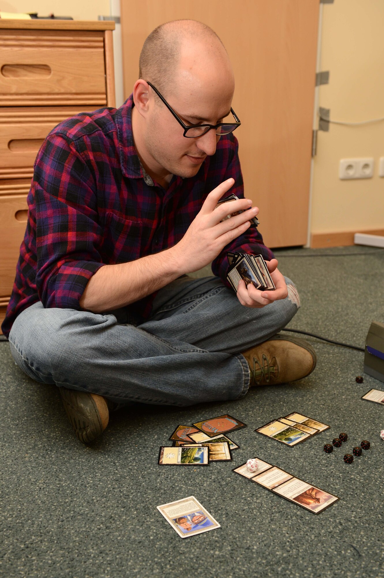 SPANGDAHLEM AIR BASE, Germany - U.S. Air Force Airman 1st Class Alex Lollar, a 606th Air Control Squadron radio frequencies transmissions systems technician from Pensacola Fla., plays a game of cards with a friend June 26, 2013. Lollar enjoys playing many different games with friends after work and on the weekends. (U.S. Air Force photo by Airman 1st Class Kyle Gese/Released)