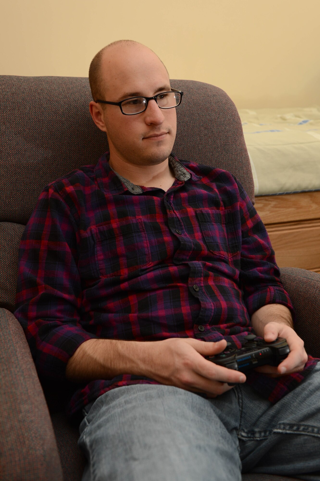 SPANGDAHLEM AIR BASE, Germany - U.S. Air Force Airman 1st Class Alex Lollar, a 606th Air Control Squadron radio frequencies transmissions systems technician from Pensacola Fla., plays a video game June 26, 2013. Lollar spends time after work relaxing and spending time with friends. (U.S. Air Force photo by Airman 1st Class Kyle Gese/Released)