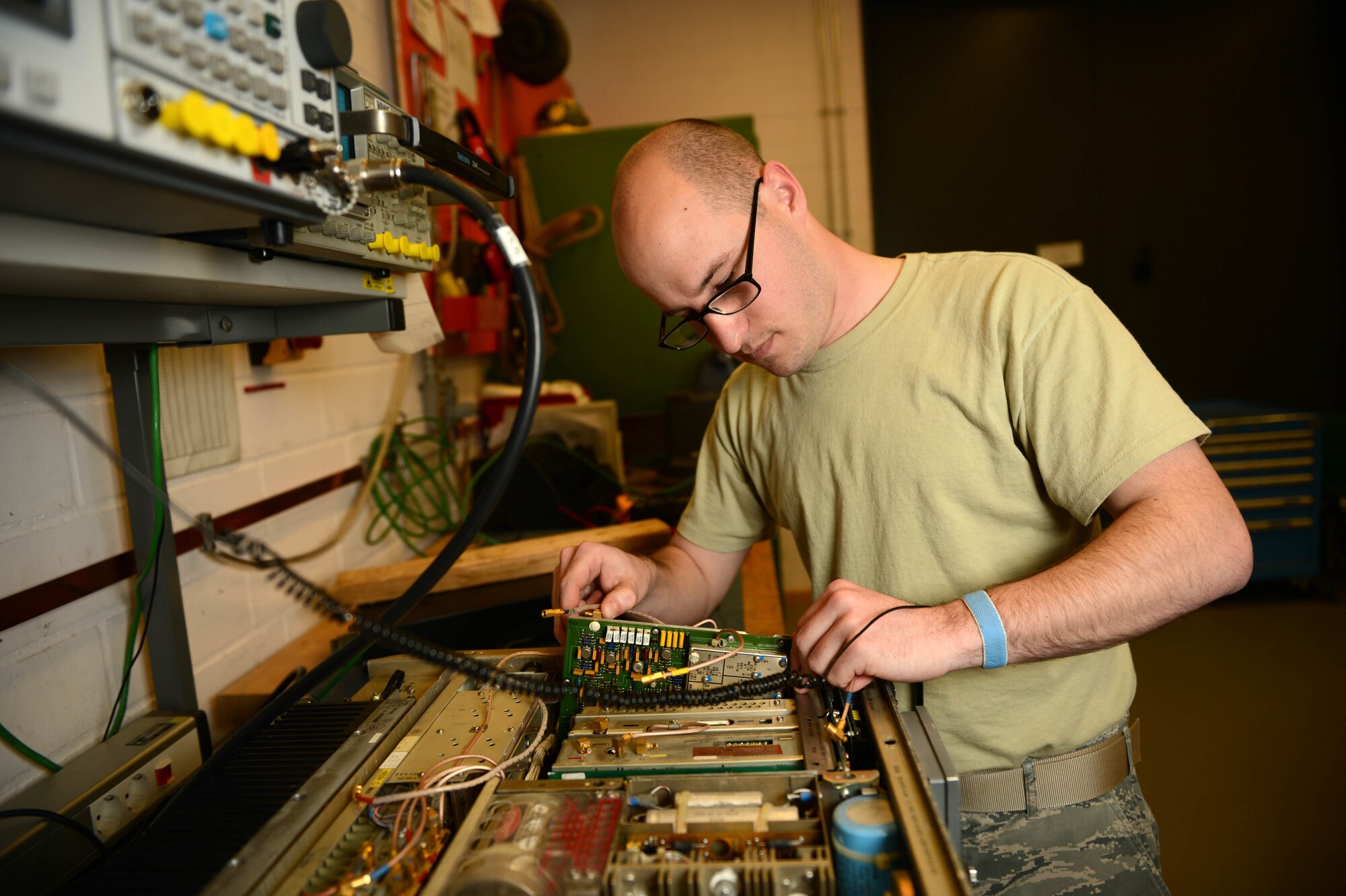 SPANGDAHLEM AIR BASE, Germany – U.S. Air Force Airman 1st Class Alex Lollar, a 606th Air Control Squadron radio frequencies transmissions systems technician from Pensacola Fla., works on a ground radio communications-171 system June 26, 2013. Lollar continues to work on radios and provide support while his colleges are downrange. (U.S. Air Force photo by Airman 1st Class Kyle Gese/Released)