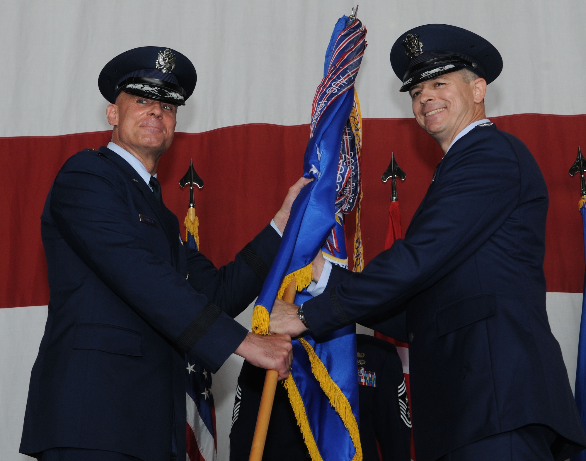 Lt. Gen. Craig Franklin, 3rd Air Force commander, passes the 39th Air Base Wing guidon to Col. Craig Wills, during a change of command ceremony July 9, 2013, at Incirlik Air Base, Turkey. The passing of the guidon symbolizes Wills’ assumption of command from the outgoing 39th ABW commander, Col. Chris Craige. (U.S. Air Force photo by Senior Airman Jarvie Wallace/Released) 