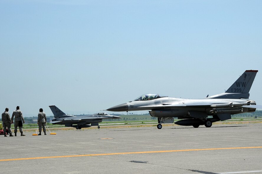 Maintenance crews assigned to the 13th Aircraft Maintenance Unit prepare as the two U.S. Air Force F-16 Fighting Falcons arrive to Chitose Air Base, Japan, July 8, 2013. Personnel from Misawa AB, Japan, had less than 30 days to prepare for an Aviation Training Relocation mission that allowed U.S. pilots to train with members of the Japan Air-Self Defense Force. (U.S. Air Force photo/Senior Airman Derek VanHorn) 