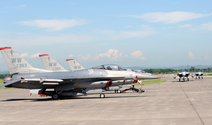 The first wave of U.S. Air Force F-16 Fighting Falcons arrive at Chitose Air Base, Japan, July 8, 2013, alongside F-15Js assigned to the Japan Air Self-Defense Force. Twelve pilots from the 35th Fighter Wing at Misawa Air Base, Japan, made the trip to Chitose AB to improve tactical air-to-air capabilities, and were supported by crews compiled of more than 75 Misawa Airmen. (U.S. Air Force photo/Senior Airman Derek VanHorn) 