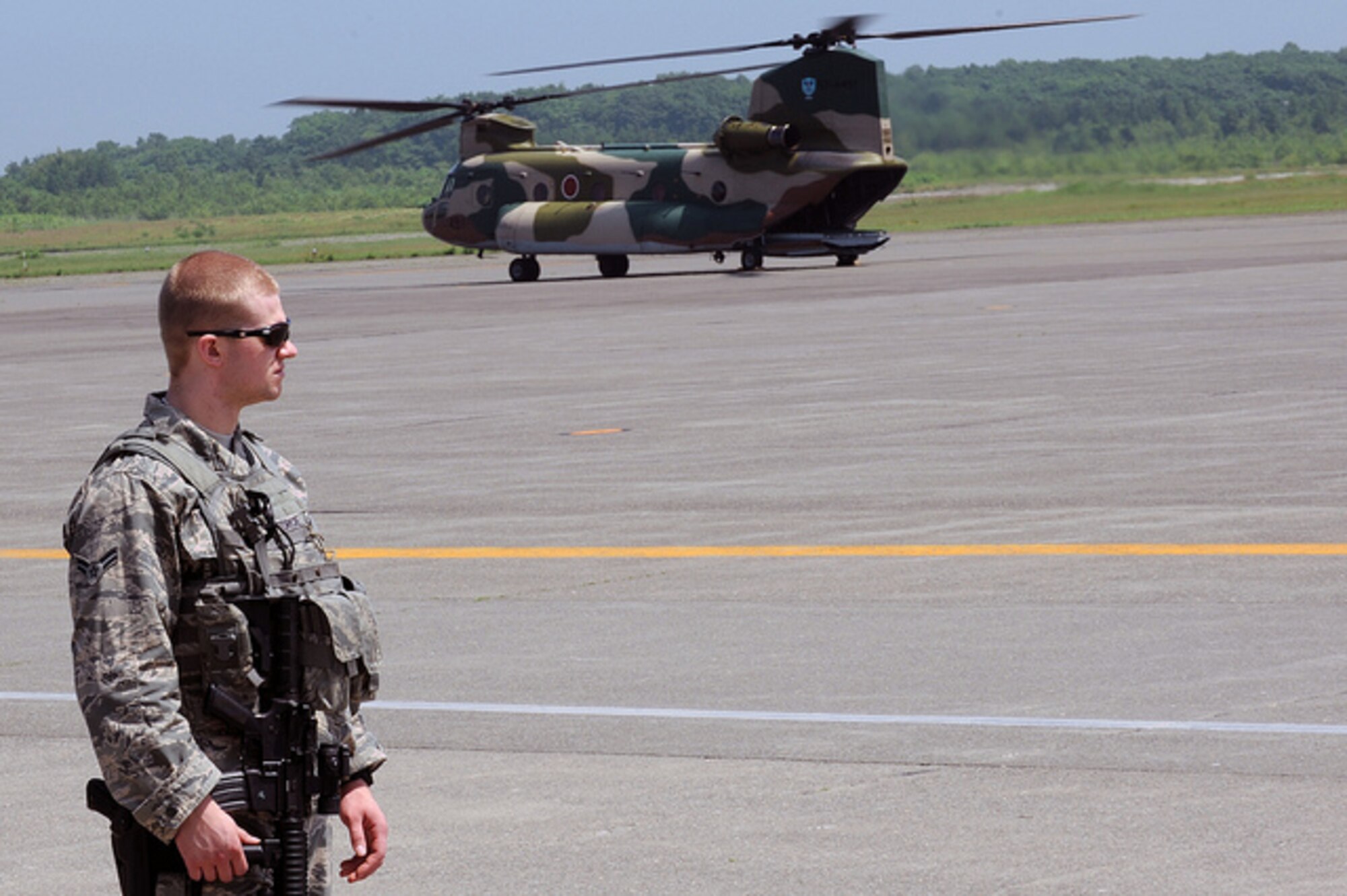 Airman First Class Tyler McHugh, 35th Security Forces Squadron, provides flight line security at Chitose Air Base, Japan, July 8, 2013. More than 100 Airmen from various squadrons at Misawa AB, Japan, provided support for a short-notice Aviation Training Relocation mission that allowed U.S. Air Force F-16 Fighting Falcons to train with pilots from the Japan Air Self-Defense Force. (U.S. Air Force photo/Senior Airman Derek VanHorn) 