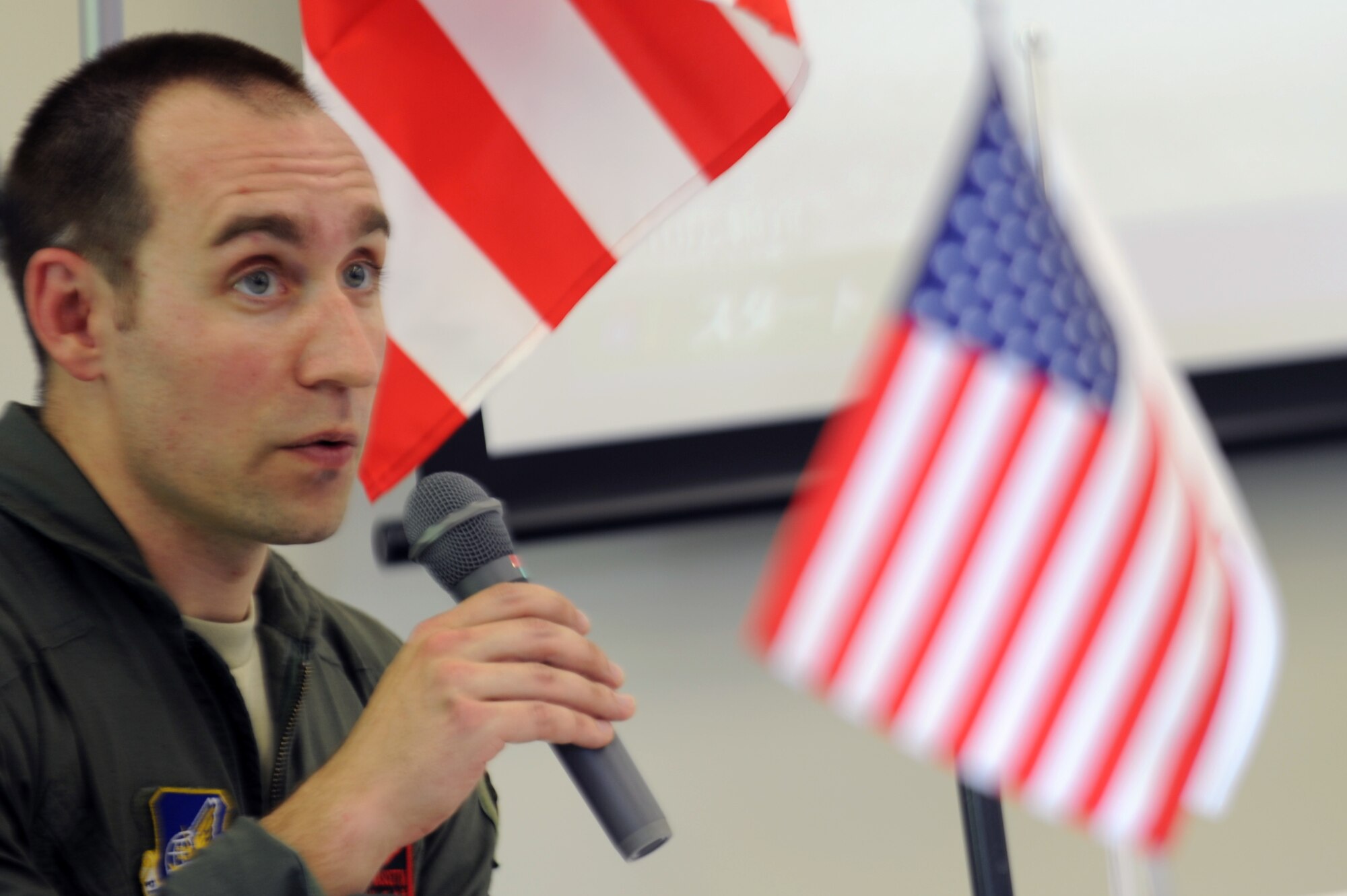 Maj. Jason Mascetta, 13th Fighter Squadron assistant director of operations, speaks to Japanese media and Chitose city council members during a press conference at Chitose Air Base, Japan, July 8, 2013. Mascetta thanked city officials for allowing U.S. forces to come to Chitose and train with the Japan Air Self-Defense Force. (U.S. Air Force photo/Senior Airman Derek VanHorn)