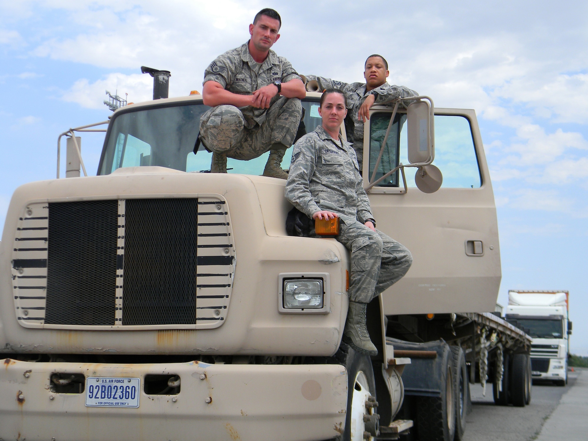 Staff Sgt. Steve MacNeil, left, Staff Sgt. Kelcey UpShaw, center and Staff Sgt. Joel Barrow, right, pose with a 376th Expeditionary Logistics Readiness Squadron truck at Transit Center at Manas, Kyrgyzstan, May 11, 2013. The trucks are used to transport passenger cargo, food deliveries to the dining facilities, supplies to Army and Air Force Exchanges Services and more. MacNeil is deployed from Luke Air Force Base, Ariz. Upshaw and Barrow are deployed out of Joint Base Andrews, Md. (U.S. Air Force/Courtesy photo)