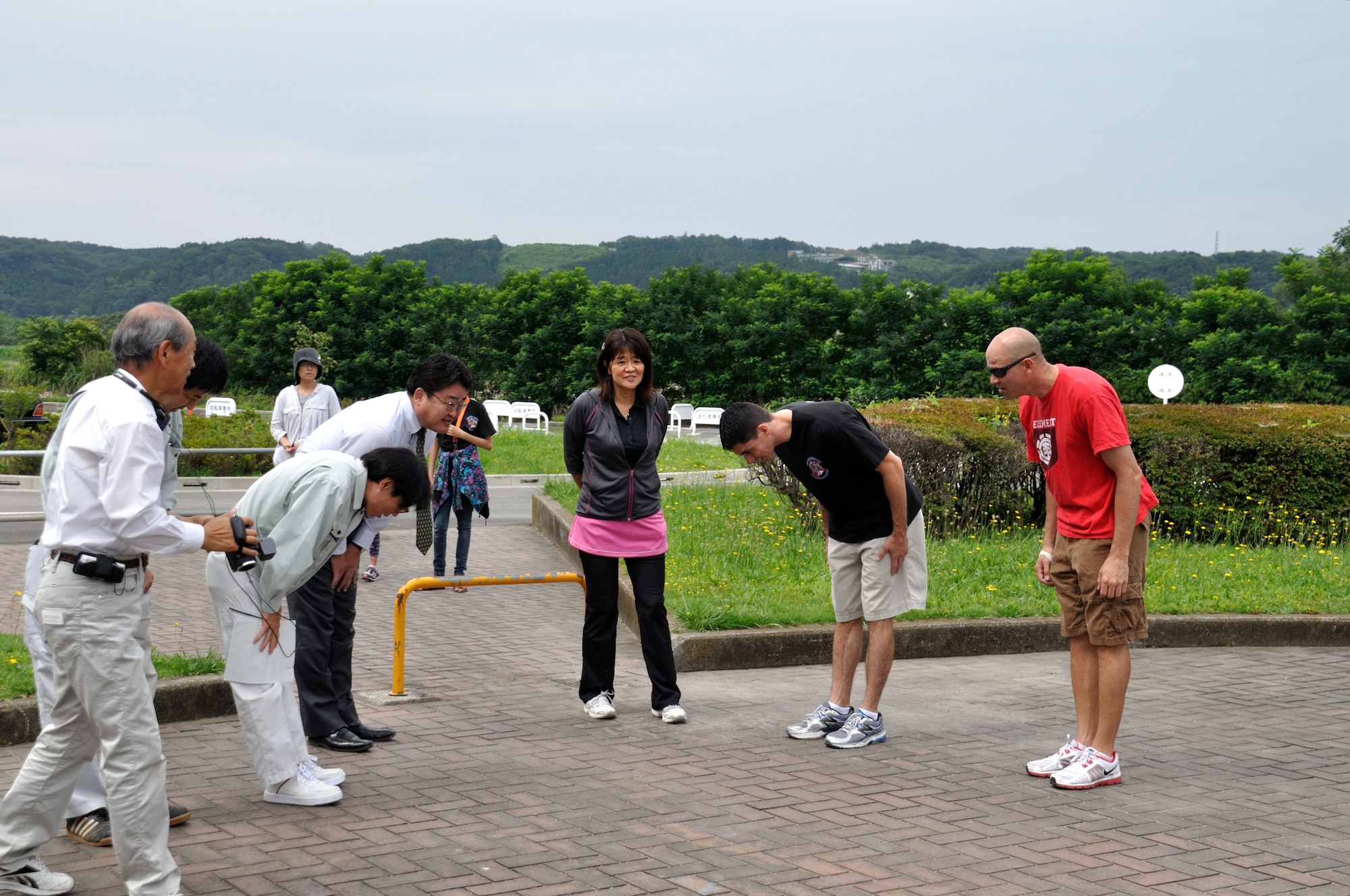 FUSSA, Japan -- Ikuo Kato, Fussa City Mayor, thanks members of the 374th
Logistics Readiness Squadron for their work in cleaning the Minami Koen park
in Fussa, Japan, July 3, 2013. The flight put together the park clean-up as
a way to get involved in the community and also enhance camaraderie within
the flight. (Courtesy photo by Yuichi Yano)

