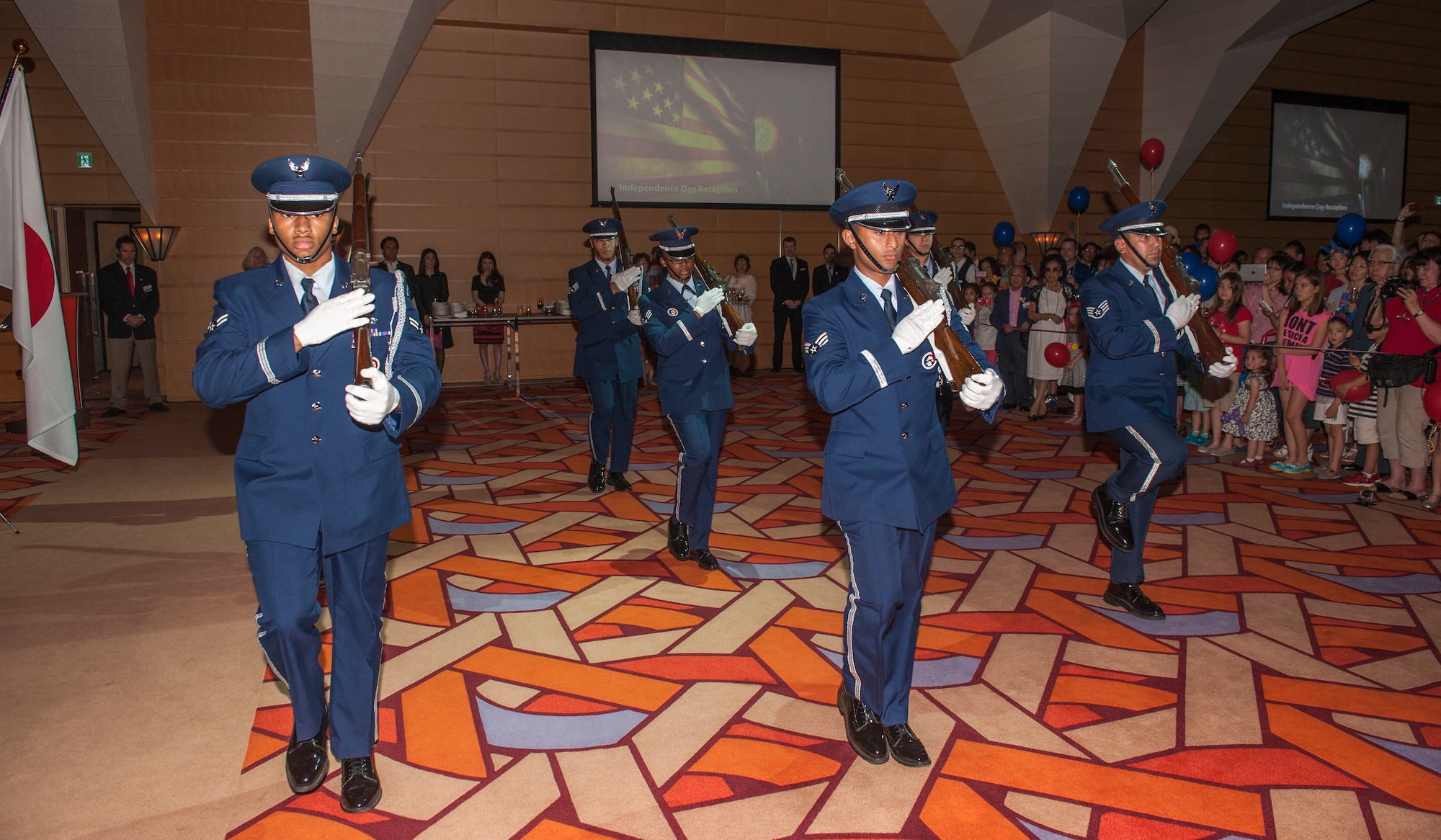 Members of Yokota Air Base’s Honor Guard Drill Team perform during the Independence Day Ceremony at the Tokyo American Club June 30, 2013. The Airmen trained extensively on how to manipulate rifles and perform drill movements. (U.S. Air Force photo by Senior Airman Michael Washburn)