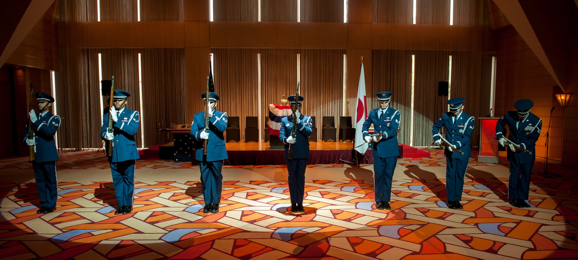 Airmen from Yokota Air Base’s Honor Guard Drill Team stand in a line during a practice run of their performance for the Independence Day Ceremony at the Tokyo American Club June 30, 2013. The team trained for three months and roughly 145 hours. (U.S. Air Force photo by Senior Airman Michael Washburn)