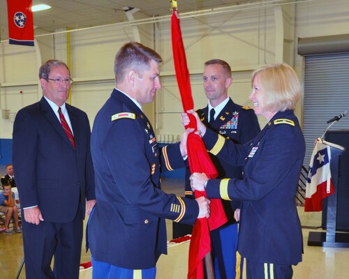 Brig. Gen. Margaret W. Burcham,  U.S. Army Corps of Engineers Great Lakes & Ohio river Division, Commander,  presents the command guidon to Lt. Col. John L. Hudson, incoming commander of the U.S. Army Corps of Engineers Nashville District, at a change of command ceremony, July 9, at the Tennessee National Guard Armory Headquarters in Nashville, Tenn.  Outgoing Commander Lt. Col. James A. Delapp and Mike W. Wilson, Deputy for Project Management look on.