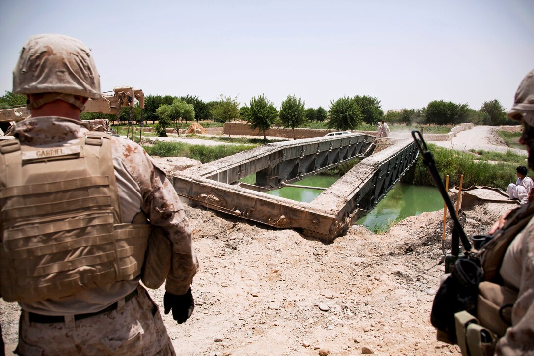 U.S. Marines work to dismantle and remove a medium girder bridge in Lashkar Gah City in Afghanistan’s Helmand province, June 29, 2013.