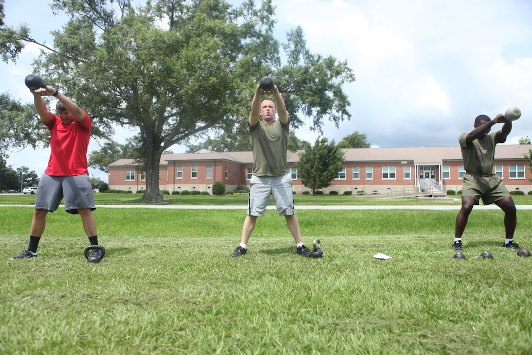 Participants of the Combat Fitness Test preparatory class complete kettle-bell lifts at Morgan Bay’s Fitness Center aboard Marine Corps Base Camp Lejeune, July 8. The class consisted of three cycles of four stations of exercises. (Photo by Lance Cpl. Justin A. Rodriguez/released)