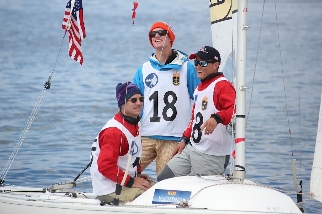 Skipper - Navy ENS Taylor Vann (center) with crew Navy LCDR Luke Suber (left) and Coast Guard LTJG Jonathan Duffett finish the final leg of race 17 at the 2013 CISM Sailing World Military Championship in Bergen, Norway 27 June to 4 July.  