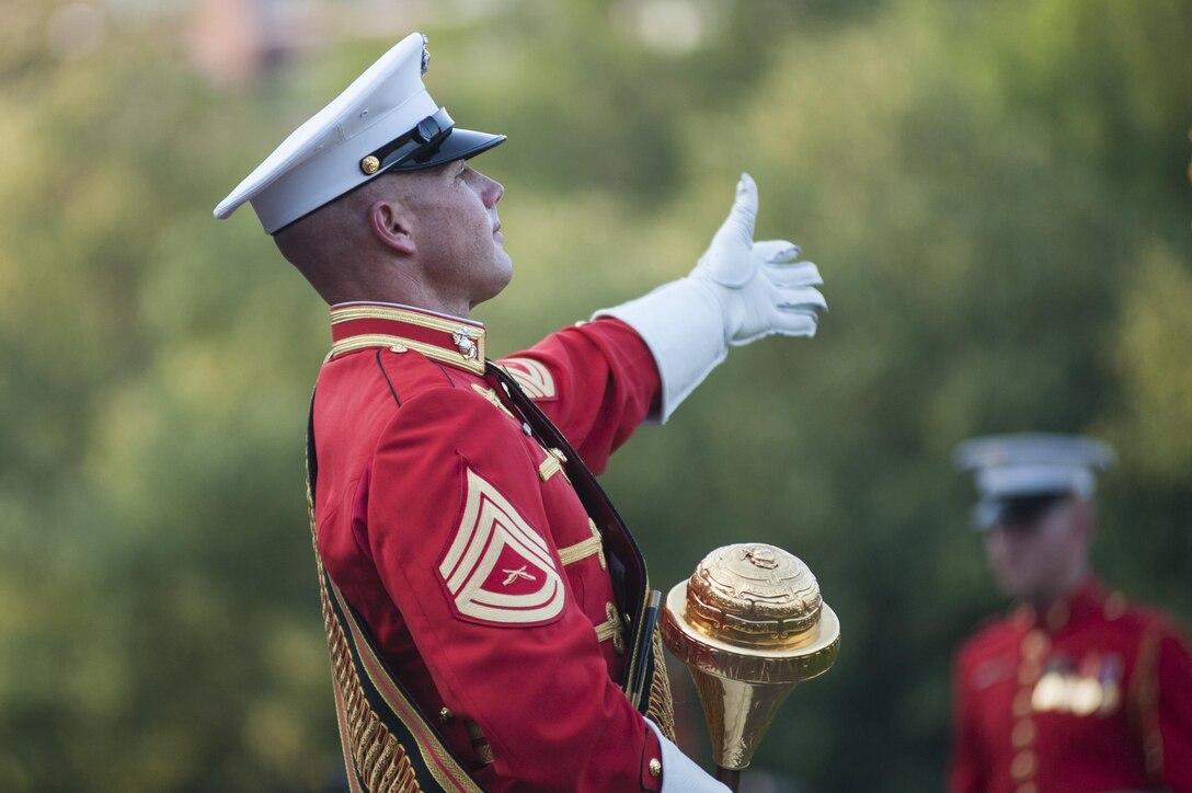 Gunnery Sgt. Keith Martinez, U.S. Marine Drum & Bugle Corps assistant drum major, performs during a Tuesday Sunset Parade at the Marine Corps War Memorial in Arlington, Va., July 9.