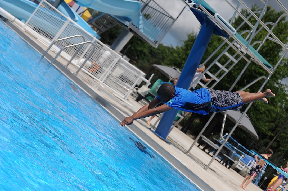 Shawn, 12, jumps off a diving board and into the water at the Quantico 50m Pool aboard Marine Corps Base Quantico, Va., on July 4, 2013. This is the second annual pool party at the Quantico 50m Pool.