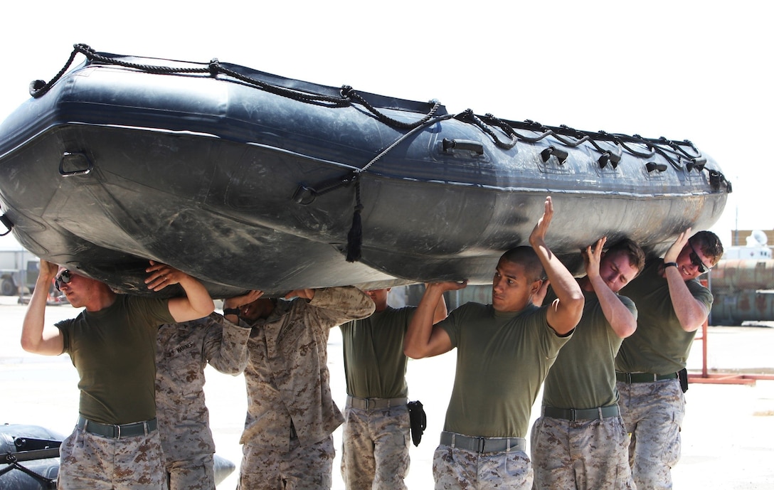 Marines with Bridge Company, 7th Engineer Support Battalion, 1st Marine Logistics Group, carry a Combat Rubber Raiding Craft during a 
field training exercise at San Clemente Island, Calif., June 27, 2013. The Marines fired M249 squad automatic weapons from a moving boat to familiarize themselves with the weapon should they have to engage targets during bridging operations during future 
deployments.
