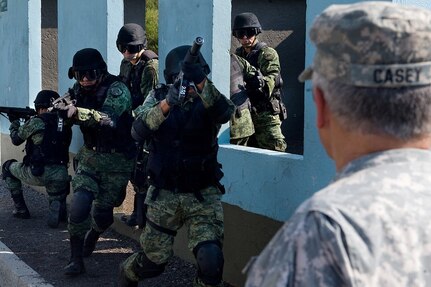 Mexican Special Forces give a breaching demonstration to Gen. George W. Casey Jr., at a military camp outside Mexico City, Mexico, Aug. 4, 2010. Casey met with Gen. Guillermo Galvan-Mexico's Secretary of National Defense-this week in Mexico City as part of a continuing effort to expand the partnership between two neighbors bound by a shared future and common understanding of security.

"The primary focus of this week's meetings was for the generals to discuss issues of shared importance to their respective troops--both of which face the challenges of operating in an era of persistent conflict. The meetings included discussions about border issues, partnership and cooperation, leveraging lessons learned from the U.S. Army's effort to put itself on a rotational cycle, and the importance of sustaining military families," said U.S. Lt. Gen. Guy Swan--the commanding general of Army North, which is the Army component responsible for Theater Security Cooperation with Mexico and Canada.

The meetings were productive, as both Gen. Casey and Gen. Galvan acknowledged their interconnectedness, and expressed a desire to continue strengthening their ties and common vision with increased partnership and cooperation. 

