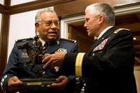 Chief of Staff of the Army, Gen. George W. Casey Jr., gives Gen. Guillermo Galvan, Secretary of Mexico's National Defense, a Remington Statue as part of a gift exchange and at the conclusion of their meeting in Mexico City, Mexico, Aug. 4, 2010.   Army photo by D. Myles Cullen (released)  
