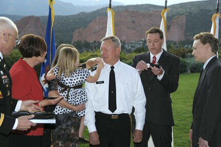 Wife Pat and son Patrick watch as son Joe, daughter Laura Fisher and granddaughter Sophia attach the three star epaulettes to the shoulders of Lt. Gen. Frank J. Grass at a promotion ceremony honoring Lt. Gen. Grass at Garden of the Gods Club in Colorado Springs 6 p.m. Sunday. Upon receiving his third star Lt. Gen. Grass, U.S. Northern Command operations officer since Sept. 2008, assumes the position of deputy commander USNORTHCOM. 

