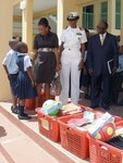 Two Bahamian students greet U.S. Ambassador Nicole Avant, Navy Lt. Cmdr. Janice Smith and Howard Newbold, District Superintendent for the North Western District, on arrival at Woodcock Primary School Sept. 9. U.S. Northern Command funded $6,000 in school supplies for local schools as part of its longstanding partnership with the people of The Bahamas and demonstrates the Department of Defense’s commitment to helping to strengthen communities and build partnerships around the world. 

