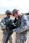 Sgt. 1st Class Somphot Hongtong, operations noncommissioned officer, Headquarters Support Company, U.S. Army North, explains the position of the aperture site on the M-16A2 Rifle Jan. 20, to Capt. Philip Lee, attorney, Army North, during the company’s advanced marksmanship training at the Camp Bullis Military Training Reservation in San Antonio. 
