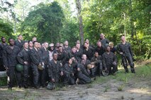Marines with Food Service Company, Combat Logistics Regiment 27, 2nd Marine Logistics Group pose for a photo after completing the endurance course aboard Camp Lejeune, N.C., July 10, 2013. The event was held to build camaraderie within the company, and give Marines a break from their usual routine.  (U.S. Marine Corps photo by Lance Cpl. Shawn Valosin)