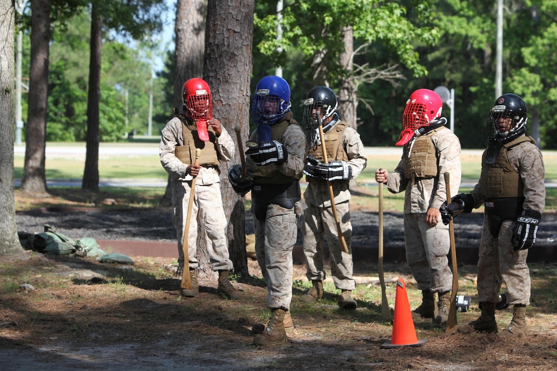 Marines with 8th Engineer Support Battalion, 2nd Marine Logistics Group and 10th Marine Regiment, 2nd Marine Division wait for a chance to practice fighting each other during a Marine Corps Martial Arts Program instructor course aboard Camp Lejeune, N.C., May 22, 2013. The Marines underwent a 15-day training program, which integrated physical, mental, and character disciplines into a close combat system. 