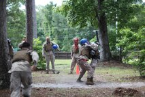 Marines with 8th Engineer Support Battalion, 2nd Marine Logistics Group and 10th Marine Regiment, 2nd Marine Division grapple with weapons of opportunity during a Marine Corps Martial Arts Program instructor course aboard Camp Lejeune, N.C., May 22, 2013. The Marines who endured the three-week course reviewed martial arts techniques and learned to supervise fighting bouts and administer exams on the course material. 