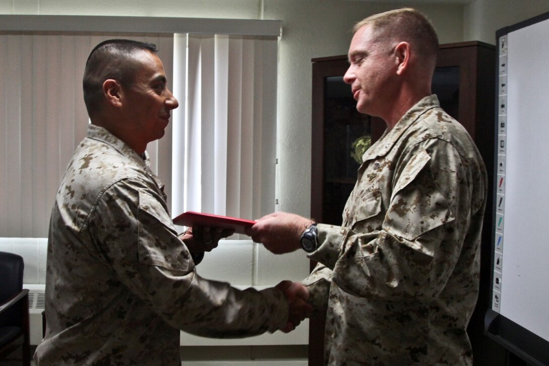 Newly promoted Lt. Col. Raul Rizzo, senior intelligence officer, 15th Marine Expeditionary Unit, shakes hands with Col. Scott D. Campbell, the unit’s former commanding officer during his promotion ceremony held in the unit’s conference room on Marine Corps Base Camp Pendleton, Calif., July 1. The 15th MEU recently returned from an eight-month deployment to the Western Pacific. Rizzo, 41, is from Myrtle Beach, S.C. (U.S. Marine Corps photo by Sgt. John Robbart III/Released)
