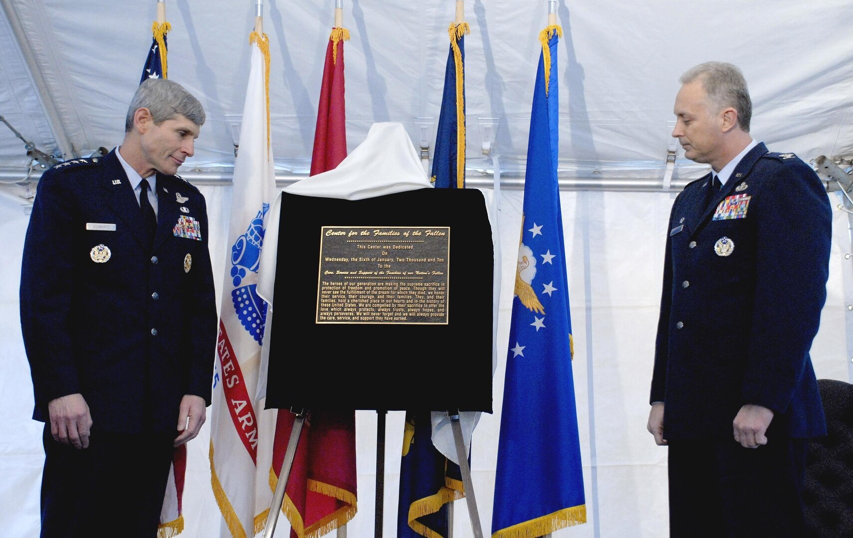 Air Force Chief of Staff Gen. Norton A. Schwartz and Air Force Col. Robert Edmondson, commander of the Air Force Mortuary Affairs Operations Center, read the inscription on the plaque they unveiled during a dedication ceremony for the Center for Families of the Fallen at Dover Air Force Base, Del., Jan. 6, 2010.