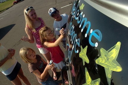 In this file photo, children decorate vehicles while they wait for Minnesota National Guardsmen to arrive before a redeployment ceremony.