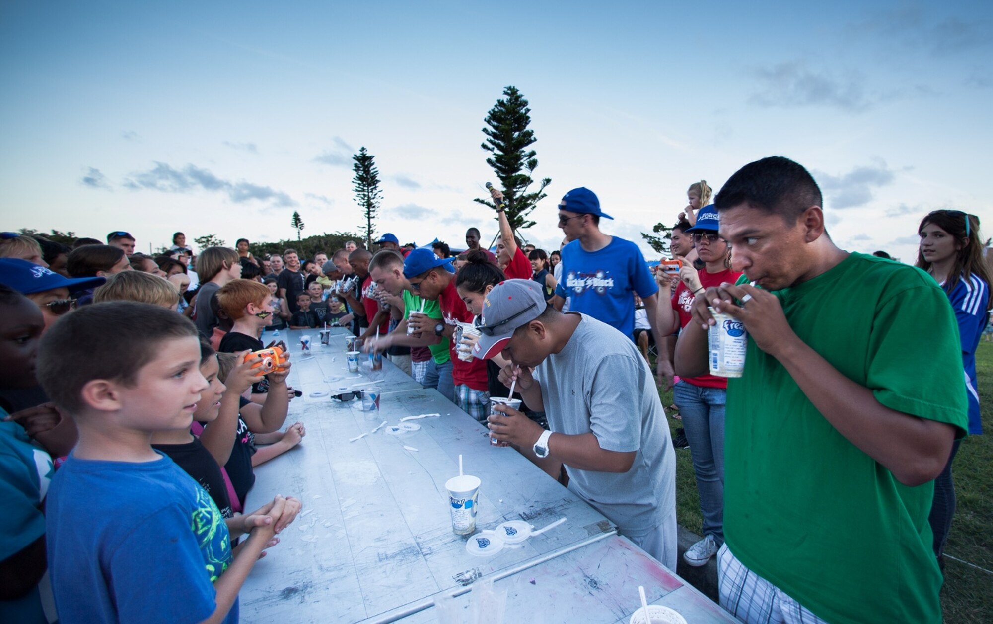 Competitors consume milkshakes during a Brain Freeze Battle at the 18th Force Support Squadron's Rockin' the Block on Kadena Air Base, Japan, June 29, 2013. About 10,000 people attended Rockin' the Block. (Courtesy photo by Chris Provan/Released)