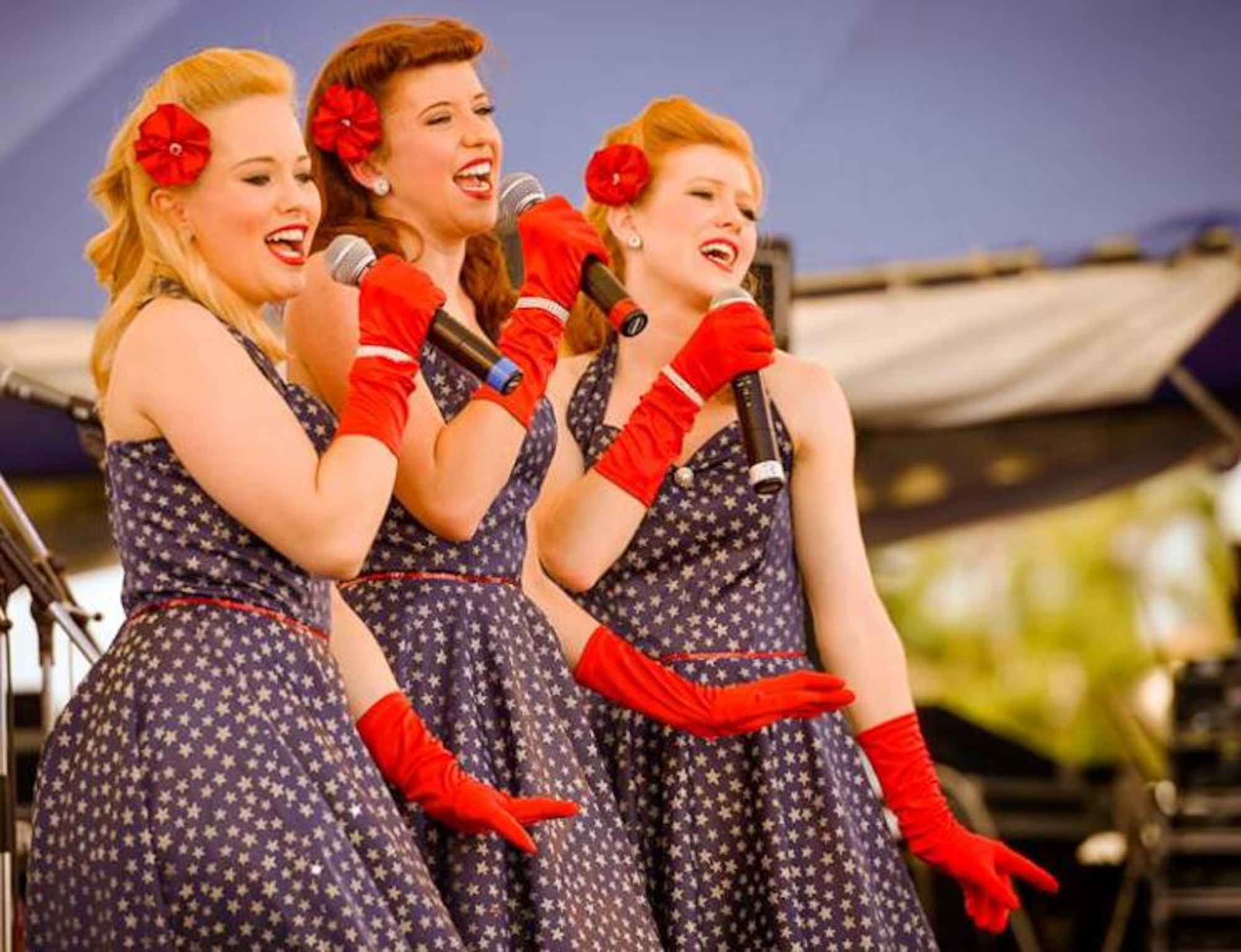 The United Service Organization Victory Belles perform during the 18th Force Support Squadron's Rockin' the Block on Kadena Air Base, Japan, June 29, 2013. Events on the Rockin' the Block stage also included the III Marine Expeditionary Force Band, Sword of the Far East and the headliner, OneRepublic. (Courtesy photo by Ryan Burger/Released)