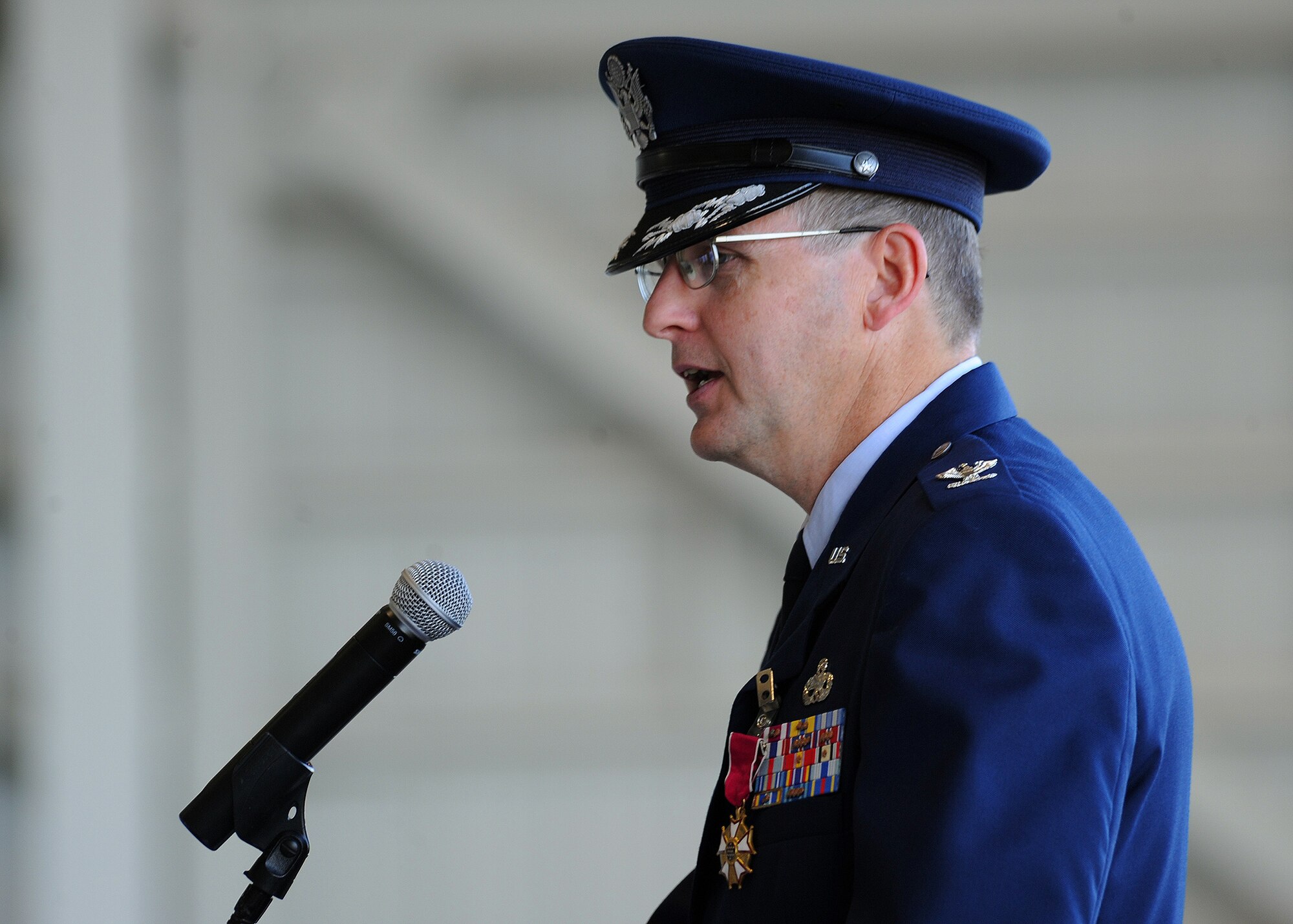 Col. Michael Novotny, former 15th Maintenance Group commander, addresses the crowd before relinquishing command to incoming Commander, Col. David Pastore, during the change of command ceremony at Hangar 19 on Joint Base Pearl Harbor-Hickam, Hawaii, July 9, 2013. During his speech, Novotny thanked the Airmen of the 15 MXG for their hard work and dedication to the mission during his tenure as commander. (U.S. Air Force photo/Tech. Sgt. Jerome S. Tayborn)