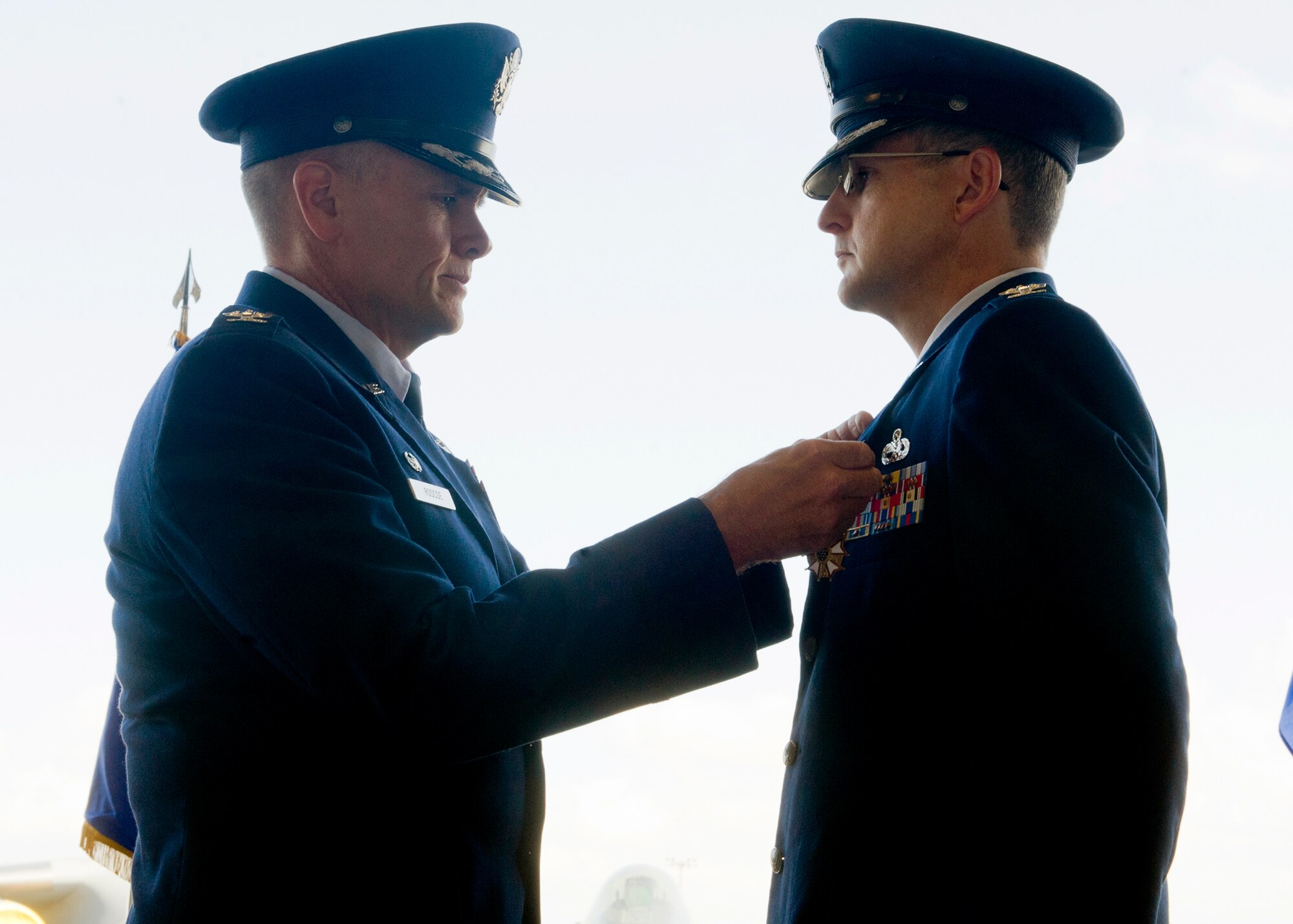 Col. Johnny Roscoe, 15th Wing commander, pins a Legion of Merit medal on Col. Michael Novotny, former 15th Maintenance Group commander, prior to his change of command ceremony at Hangar 19 on Joint Base Pearl Harbor-Hickam, Hawaii, July 9, 2013. The Legion of Merit is a military award of the United States Armed Forces that is given for exceptionally meritorious conduct in the performance of outstanding services and achievements. (U.S. Air Force photo/Tech. Sgt. Jerome S. Tayborn)