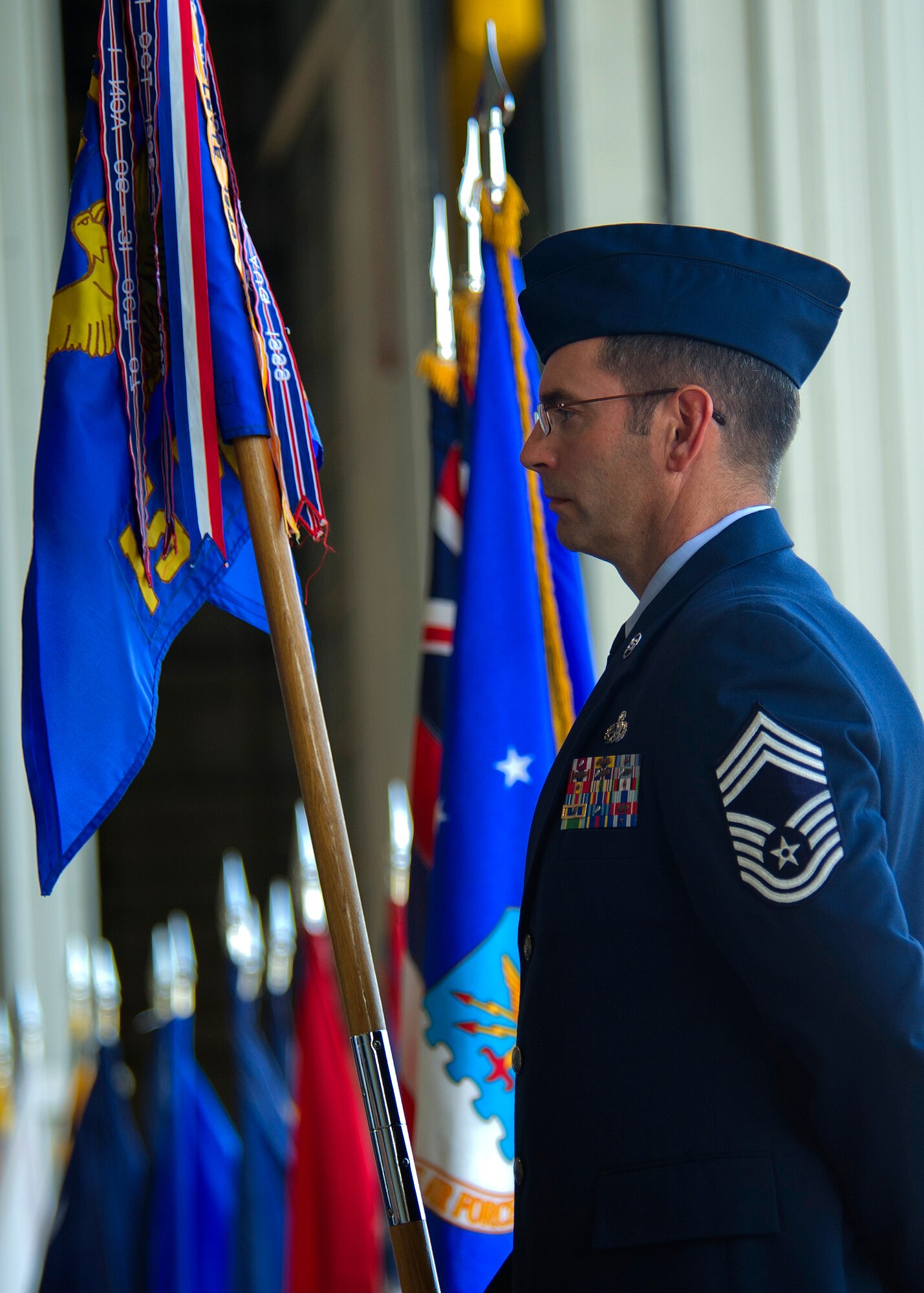 Chief Master Sgt. Jonathan Trampel, 15th Maintenance Group superintendent, stands at parade rest while holding his unit’s guidon during the 15 MXG change of command ceremony at Hangar 19 on Joint Base Pearl Harbor Hickam-Hawaii, July 9, 2013. This ceremony is rooted in military history dating back to the late 17th century. Organizational flags were developed with color arrangements and symbols unique to each particular unit. To this flag and its commander, the members of the unit would dedicate their loyalty and trust. (U.S. Air Force photo/Tech. Sgt. Jerome S. Tayborn)