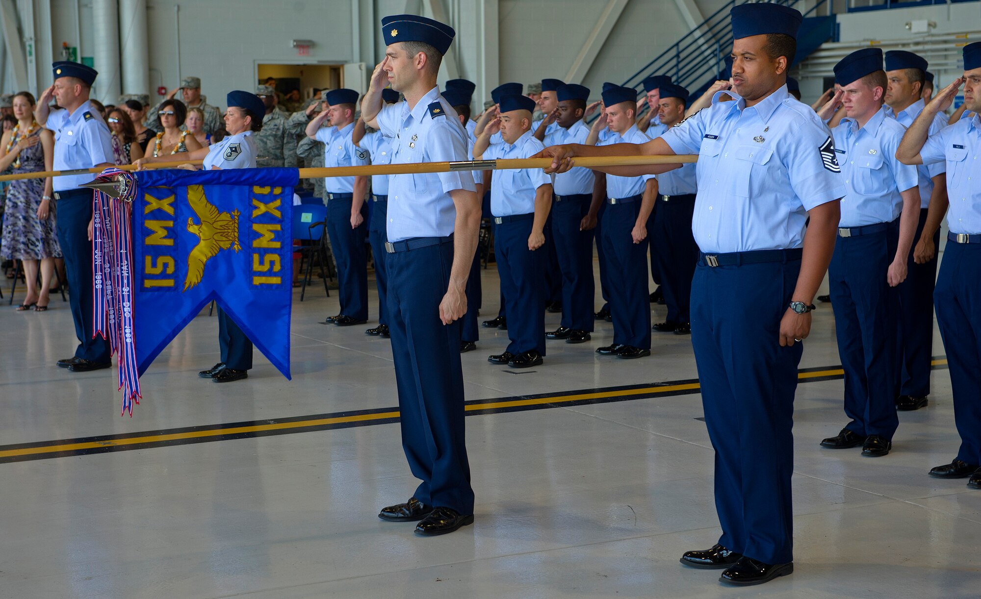 Members of the 15th Maintenance Squadron present the colors during the singing of the national anthem at the 15th Maintenance Group change of command ceremony where Col. Michael Novotny relinquished command to Col. David Pastore at Hangar 19 on Joint Base Pearl Harbor-Hickam, Hawaii, July 9, 2013. The 15 MXG mission is to maintain an integrated total force enabling mission accomplishment with reliable, serviceable, and safe aircraft and equipment.  (U.S. Air Force photo/Tech. Sgt. Jerome S. Tayborn)