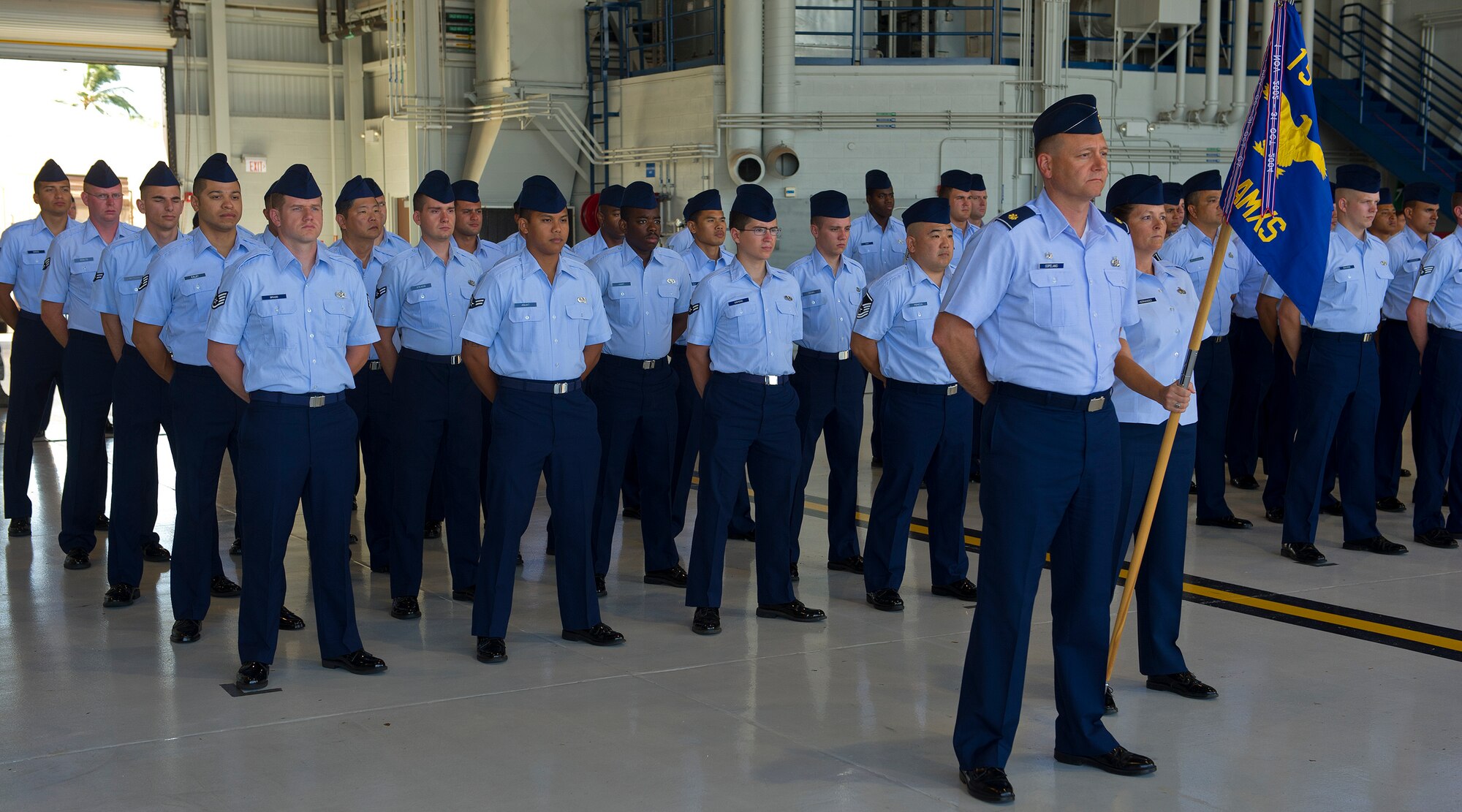 Members of the 15th Aircraft Maintenance Squadron stand in formation during the 15th Maintenance Group change of command ceremony where Col. Michael Novotny relinquished command to Col. David Pastore at Hangar 19 on Joint Base Pearl Harbor-Hickam, Hawaii, July 9, 2013. The 15 MXG vision is building and maturing relationships and processes to project peace and power in the Pacific and beyond. (U.S. Air Force photo/Tech. Sgt. Jerome S. Tayborn)