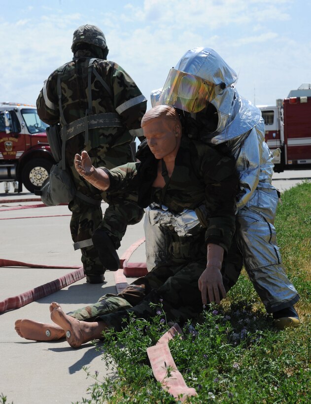 A member of the 28th Civil Engineer Squadron Fire Department pulls a dummy out of a simulated building fire during an operational readiness exercise at Ellsworth Air Force Base, S.D., July 10, 2013. During the exercise the base practiced performing mission priorities in a deployed environment to maintain mission readiness. (U.S. Air Force photo by Airman 1st Class Rebecca Imwalle/Released)