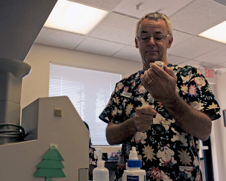 Civilian Bruce Weber, 355th Aerospace Medicine Squadron veterinary medical officer, prepares vaccines for an animal patient at the Vet Clinic on Davis-Monthan Air Force Base, Ariz., July 10, 2013. Services are open to anyone with a valid military identification card, which entitles them to governmental medical care. (U.S. Air Force photo by Senior Airman Christine Griffiths/Released) 