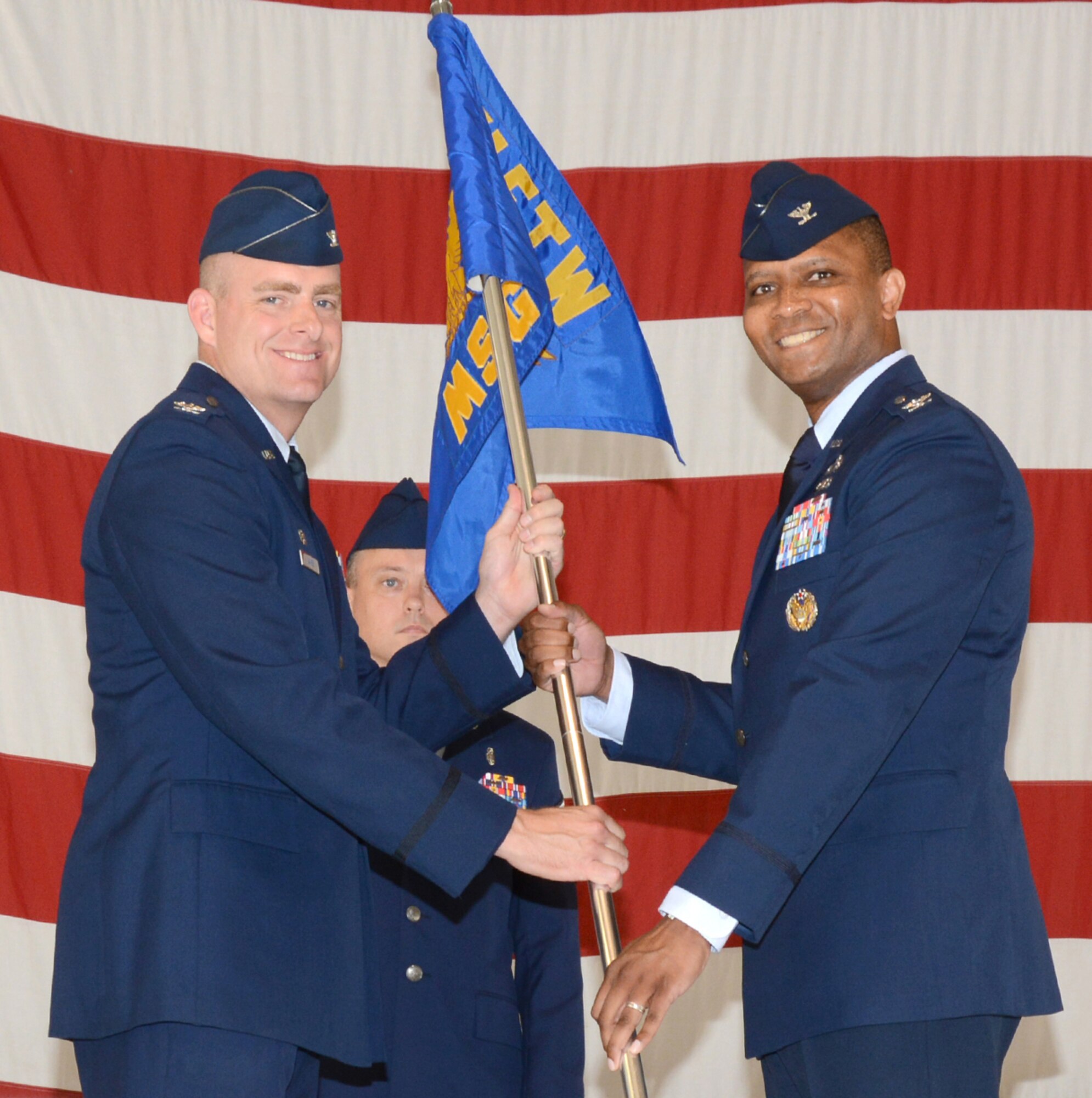 Col. Christopher Daniels, right, accepts the group guidon from 71st Flying Training Wing commander, Col. Darren James, during a 71st Mission Support Group assumption of command ceremony held July 9 in Hangar 199 at Vance Air Force Base, Okla. (U.S. Air Force photo/ Terry Wasson) 