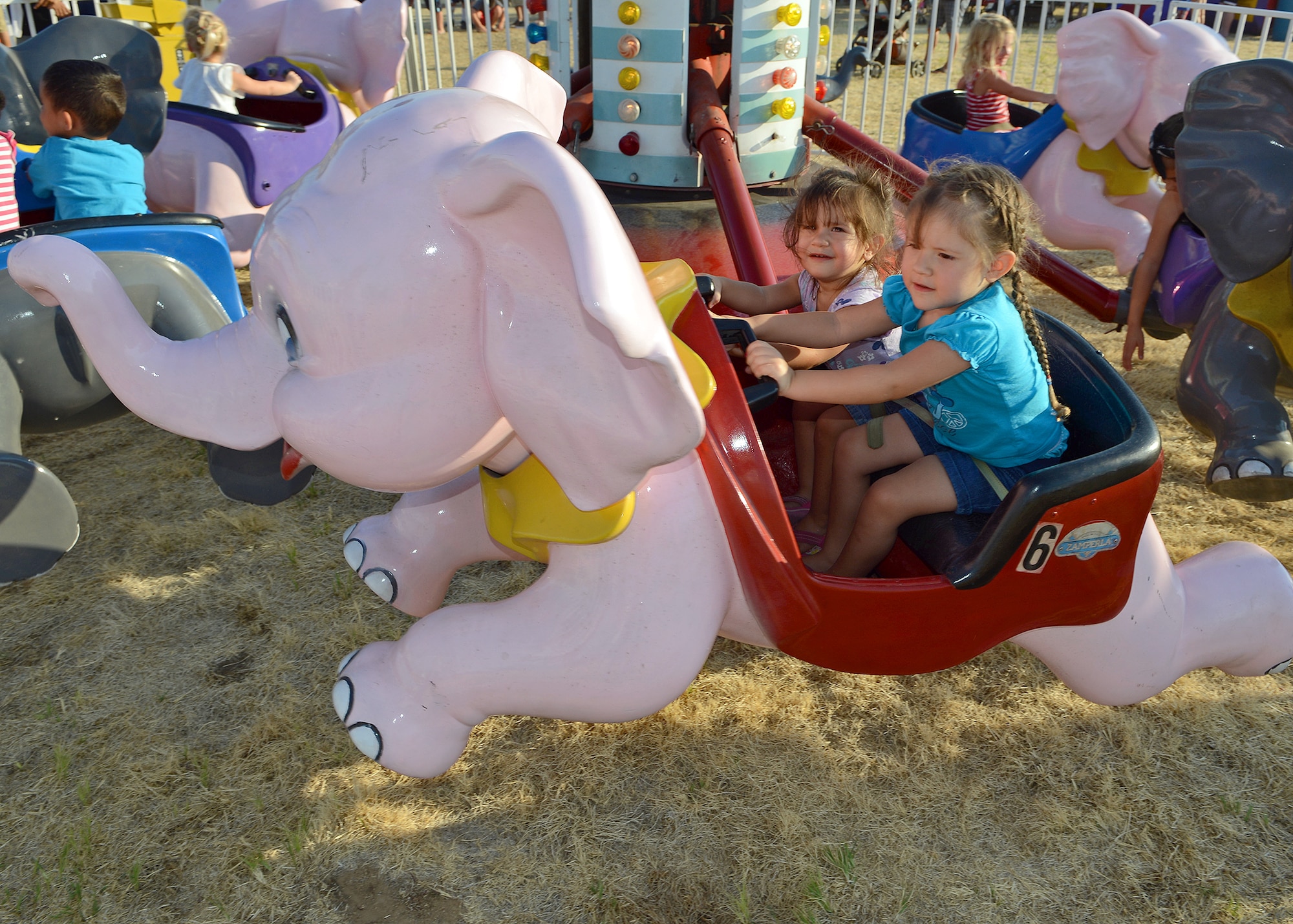 Children from the base community took part in one of the many rides that were available to attendees during the 2013 Freedom Fest at Wings and Roberts Fields on July 4. (U.S. Air Force photo by Jet Fabara)
