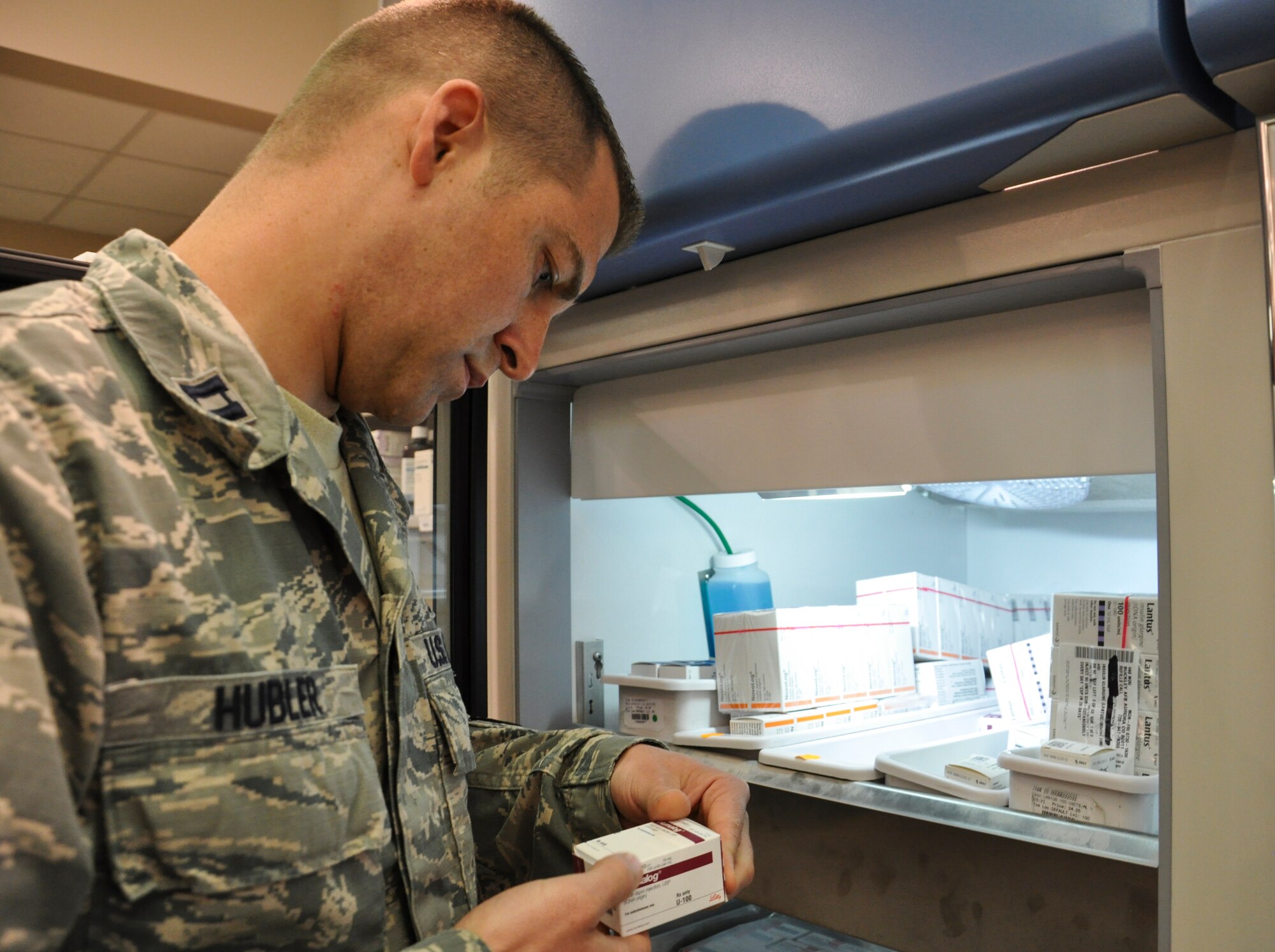 Capt. (Dr.) Sam Hubler, 460th Medical Group pharmacy operations officer, verifies medication from a refrigerated cabinet July 1, 2013, at the pharmacy on Buckley Air Force Base, Colo. Buckley recently became part of an internship rotation program through the University Of Colorado School Of Pharmacy. (U.S. Air Force photo by Staff Sgt. Nicholas Rau/Released)