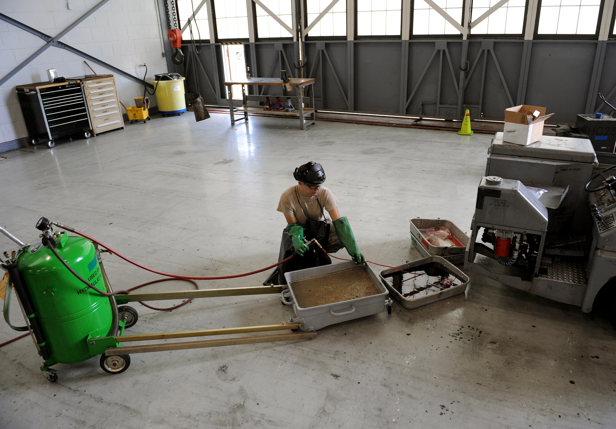 Airman 1st Class Chambray Bartley, 2nd Maintenance Squadron Aerospace Ground Equipment flight, reclaims hydraulic fluid on Barksdale Air Force Base, La., July 8, 2013. Fluid is reclaimed, so it can be sent to a facility where impurities are removed, and the fluid reused. (U.S. Air Force photo/Airman 1st Class Benjamin Gonsier)

