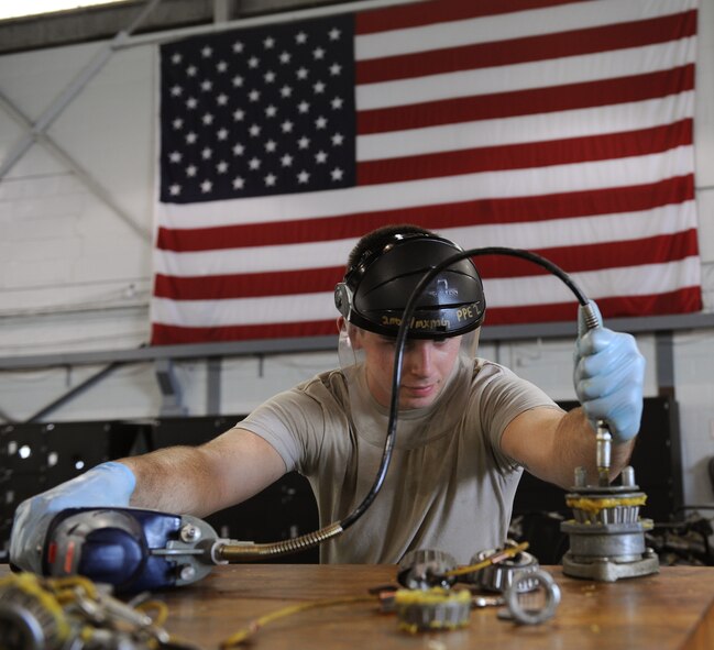 Airman 1st Class Eric Hawkins, 2nd Maintenance Squadron Aerospace Ground Equipment flight, greases a wheel bearing on Barksdale Air Force Base, La., July 8, 2013. Grease is used to decrease the metal on metal contact between parts, which helps increase its longevity. (U.S. Air Force photo/Airman 1st Class Benjamin Gonsier)  