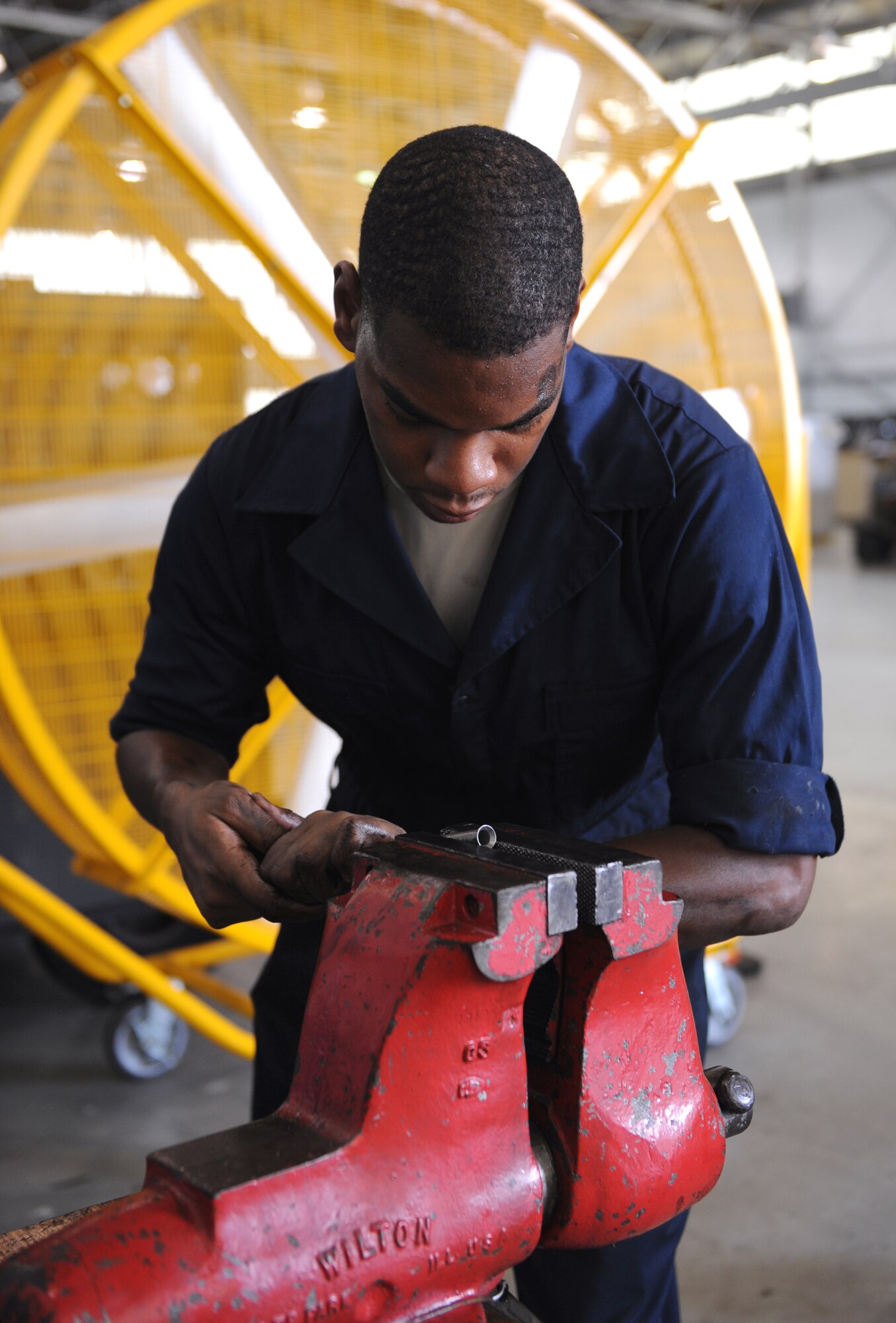 Senior Airman Marcus Smith, 2nd Maintenance Squadron Aerospace Ground Equipment flight, readies a hydraulic line on Barksdale Air Force Base, La., July 8, 2013. When new parts are received, they are modified so they can be installed into equipment properly. (U.S. Air Force photo/Airman 1st Class Benjamin Gonsier)
